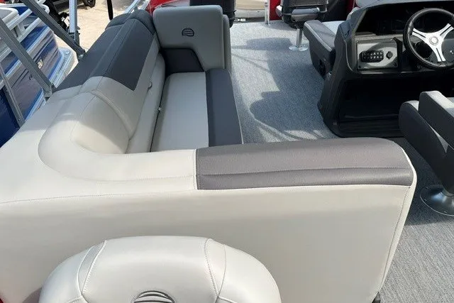 Slide: The Image of 2026 Sun Tracker Fishin' Barge 22 DLX interior with plush seating and modern helm. - 13