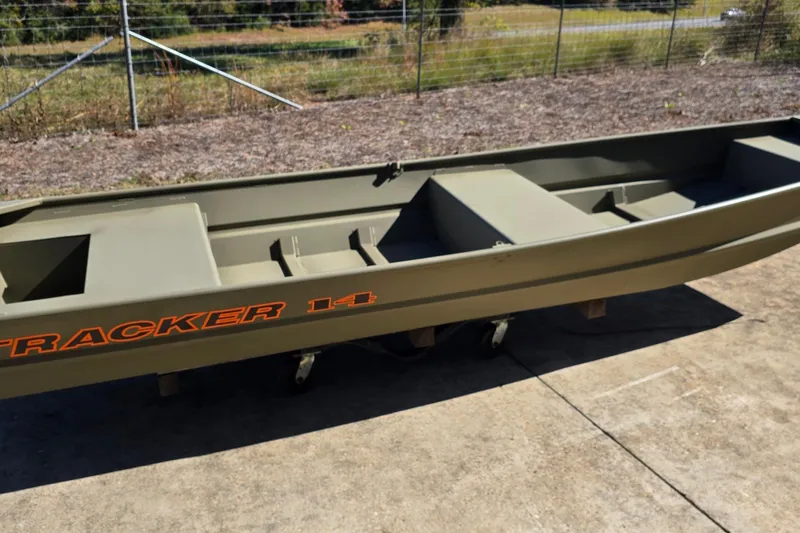 The Image of 2026 Tracker Grizzly 14 Jon boat on concrete surface, outdoors. - 0