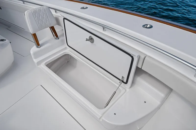 Slide: The Image of 2026 Valhalla Boatworks V-37 open storage compartment on deck, near ocean. - 11