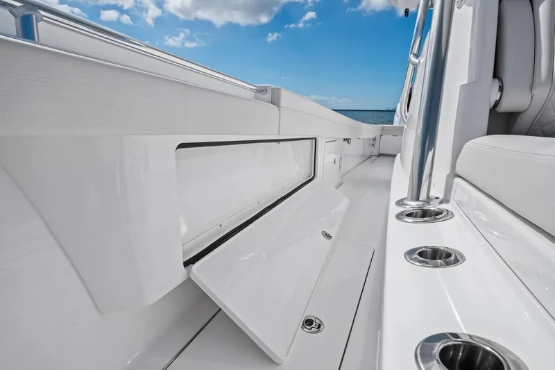 Slide: The Image of 2026 Valhalla Boatworks V-37 interior with open storage compartment and cup holders. - 12