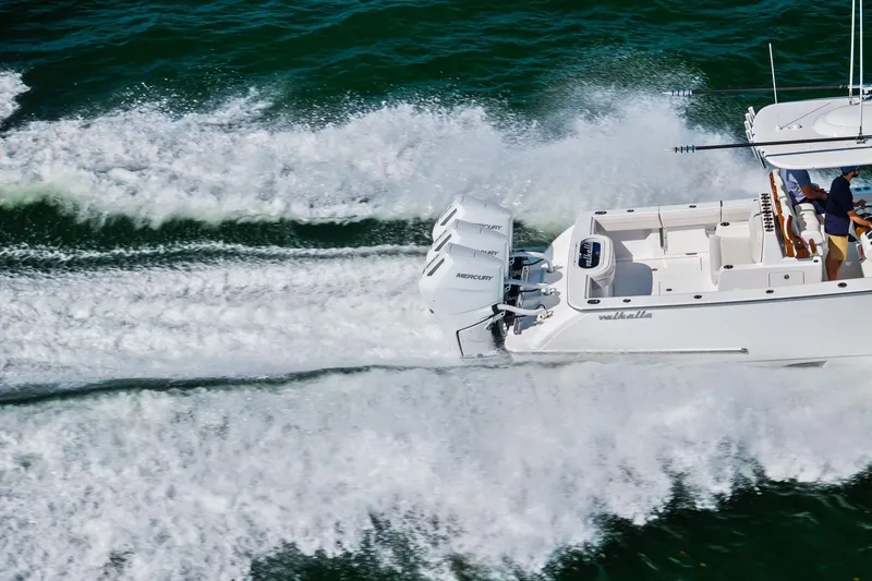Slide: The Image of 2026 Valhalla Boatworks V-37 speeding on water, showcasing powerful Mercury engines. - 18
