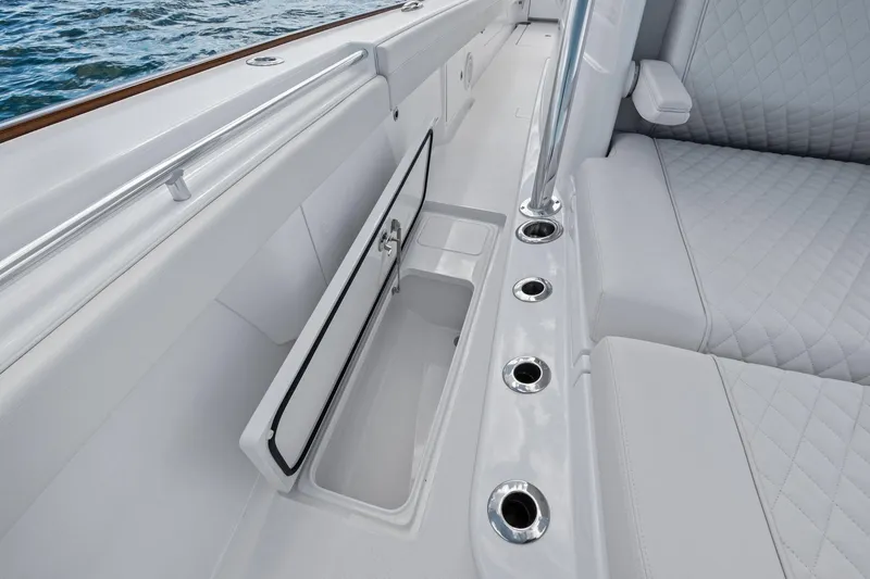 Slide: The Image of 2026 Valhalla Boatworks V-37 interior with open storage compartment and cushioned seating. - 21