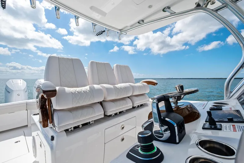 Slide: The Image of 2026 Valhalla Boatworks V-37 cockpit with luxurious seating and controls, ocean view. - 23