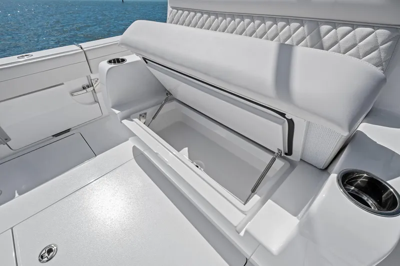 Slide: The Image of 2026 Valhalla Boatworks V-37 interior storage compartment with cushioned seating and cup holder. - 45