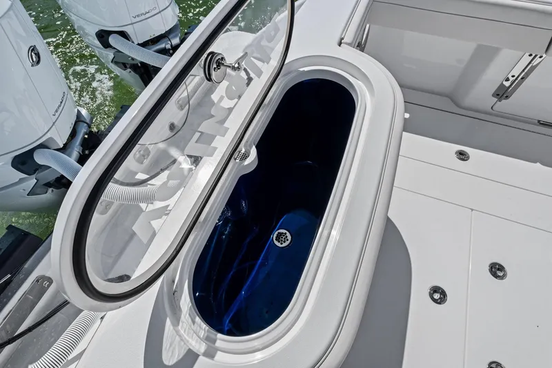 Slide: The Image of 2026 Valhalla Boatworks V-37 livewell with open lid, showcasing interior and outboard engines. - 52