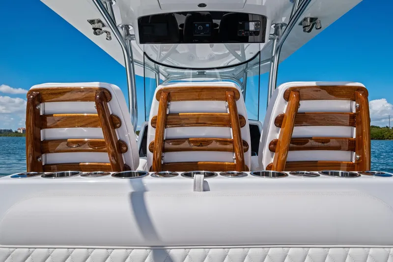 Slide: The Image of 2026 Valhalla Boatworks V-37 interior with elegant wooden seating and cup holders. - 57