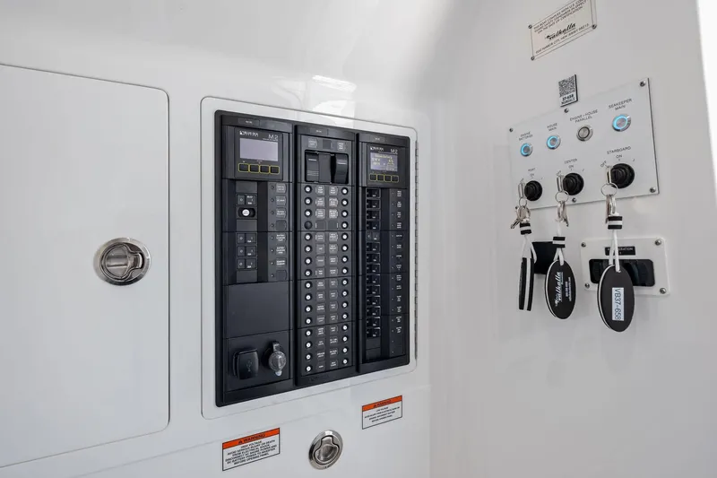 Slide: The Image of 2026 Valhalla Boatworks V-37 control panel with switches and key fobs. - 58