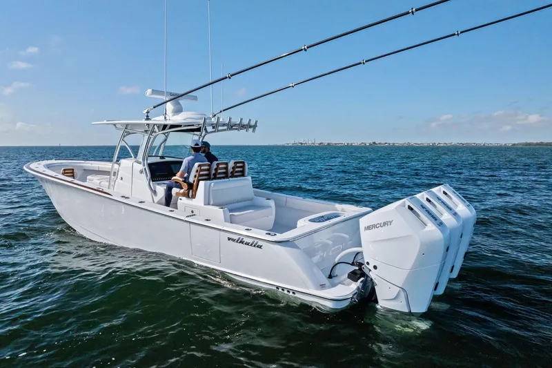 Slide: The Image of 2026 Valhalla Boatworks V-37 cruising on open water with triple Mercury engines. - 68