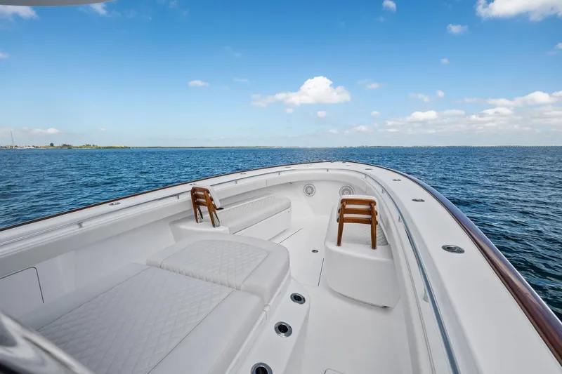 Slide: The Image of 2026 Valhalla Boatworks V-37 on open water, showcasing luxurious deck and seating. - 7