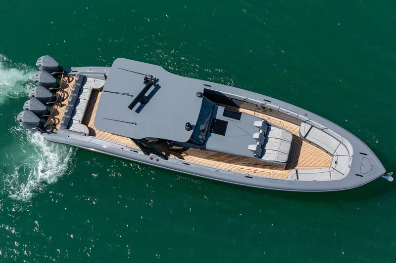 Slide: The Image of 2023 Midnight Express 43 Solstice luxury boat cruising on clear blue water. - 12