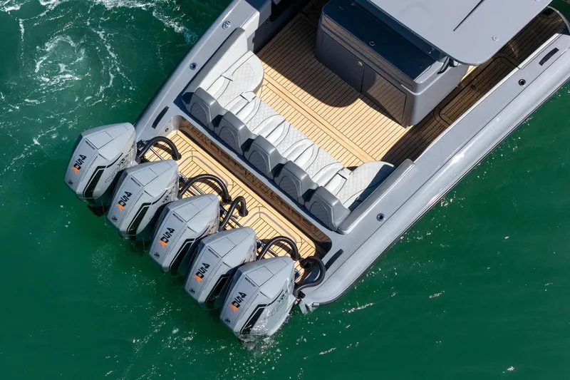 Slide: The Image of 2023 Midnight Express 43 Solstice boat with five powerful outboard engines on turquoise water. - 14