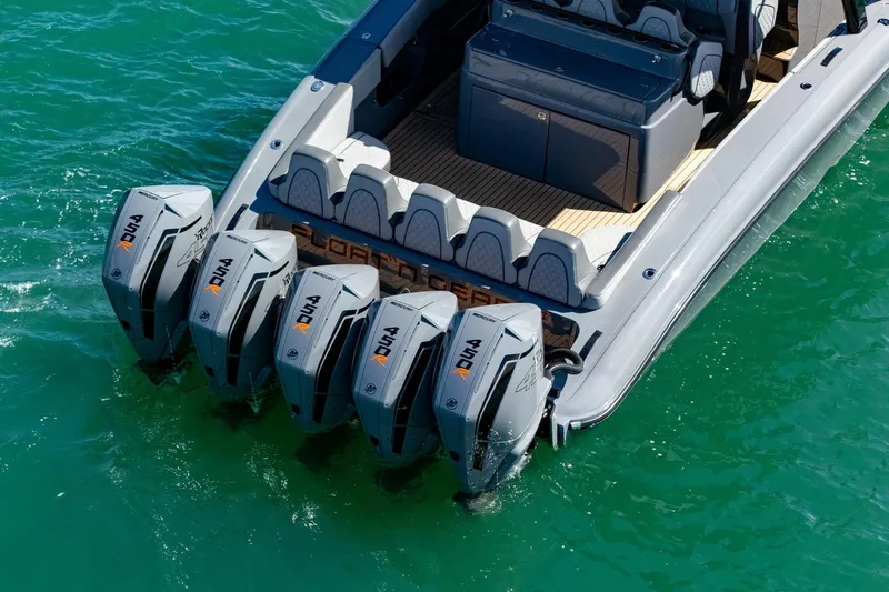 Slide: The Image of 2023 Midnight Express 43 Solstice boat with four powerful outboard engines on turquoise water. - 15