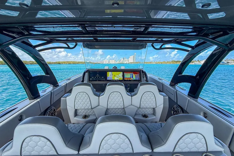 Slide: The Image of Interior view of 2023 Midnight Express 43 Solstice boat with luxurious seating and navigation screens. - 19