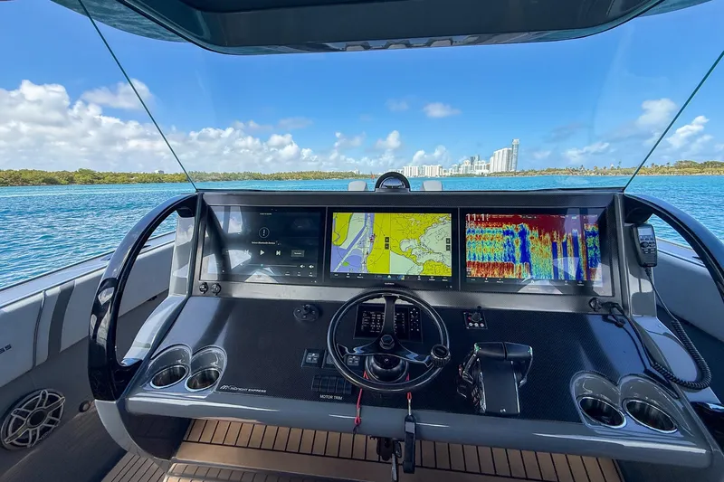 Slide: The Image of Cockpit view of 2023 Midnight Express 43 Solstice boat with navigation screens. - 20