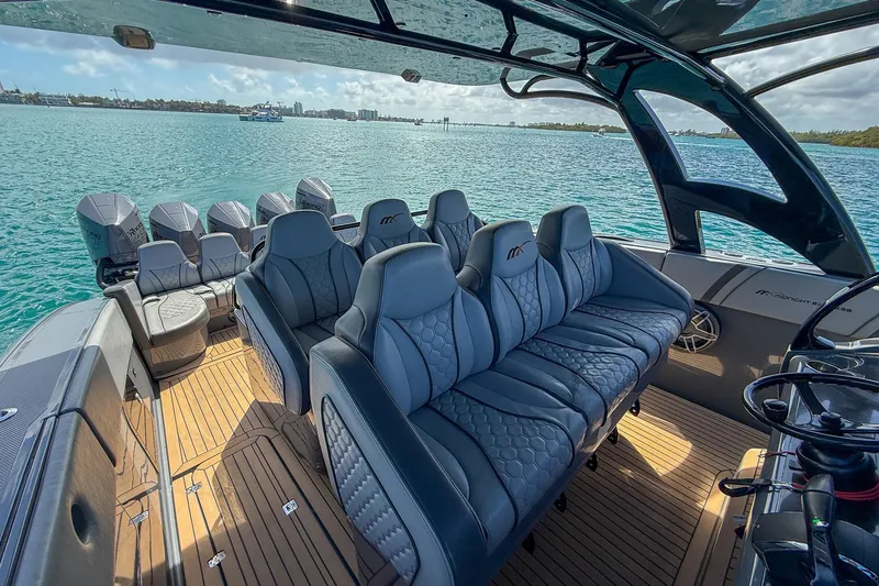 Slide: The Image of Luxurious interior of 2023 Midnight Express 43 Solstice boat on serene water. - 21
