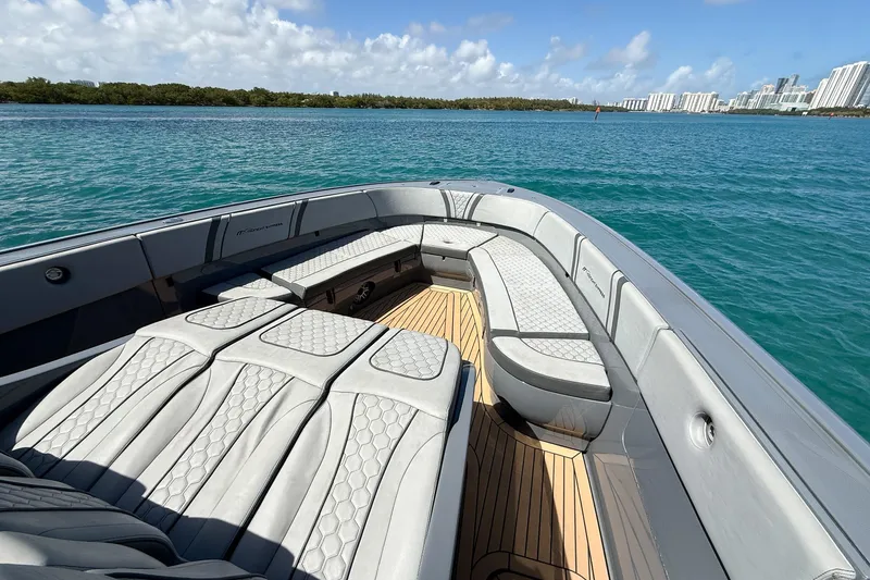 Slide: The Image of Luxury seating on 2023 Midnight Express 43 Solstice boat, cruising on clear blue waters. - 22
