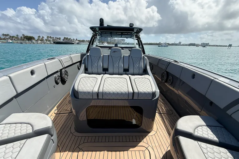 Slide: The Image of 2023 Midnight Express 43 Solstice luxury boat interior with plush seating and ocean view. - 23