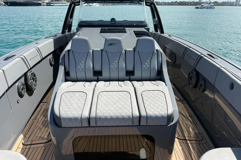 Slide: The Image of 2023 Midnight Express 43 Solstice luxury boat interior with plush seating on open water. - 24