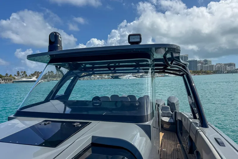 Slide: The Image of 2023 Midnight Express 43 Solstice boat on turquoise water with city skyline background. - 26