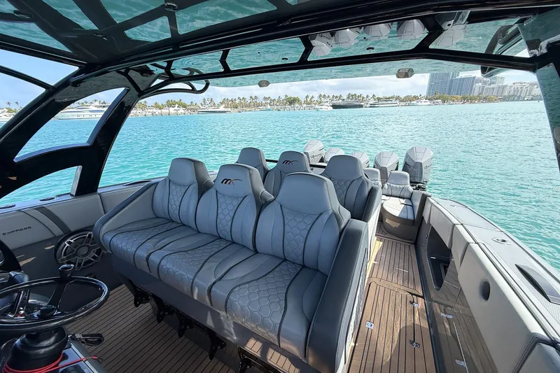 Slide: The Image of 2023 Midnight Express 43 Solstice luxury boat interior with plush seating on turquoise waters. - 27