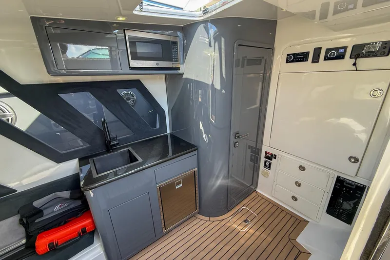 Slide: The Image of Luxurious interior of 2023 Midnight Express 43 Solstice boat with modern kitchenette and sleek design. - 31