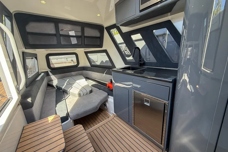 Slide: The Image of Luxurious interior of 2023 Midnight Express 43 Solstice boat with modern seating and kitchenette. - 33