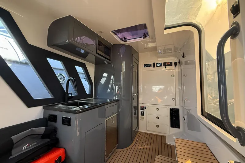 Slide: The Image of Interior of 2023 Midnight Express 43 Solstice boat with modern kitchen and sleek design. - 35