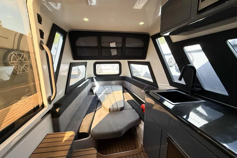 Slide: The Image of Luxurious interior of 2023 Midnight Express 43 Solstice boat with modern seating and kitchenette. - 36