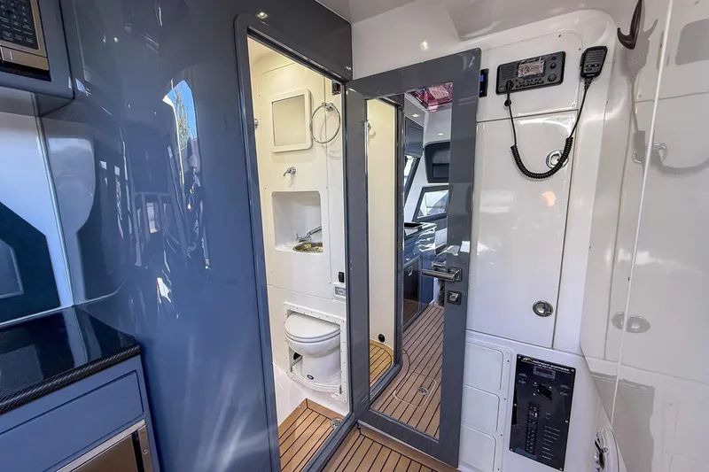 Slide: The Image of Interior of 2023 Midnight Express 43 Solstice boat, featuring a compact bathroom and modern amenities. - 39