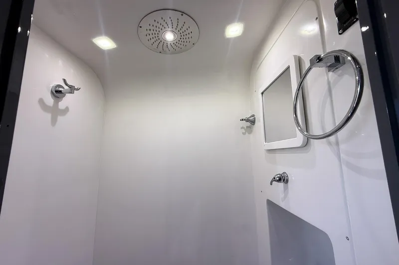 Slide: The Image of 2023 Midnight Express 43 Solstice boat interior shower with modern fixtures and lighting. - 41