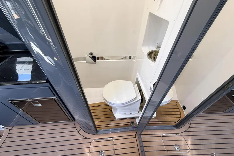 Slide: The Image of 2023 Midnight Express 43 Solstice yacht bathroom with modern fixtures and wooden flooring. - 43