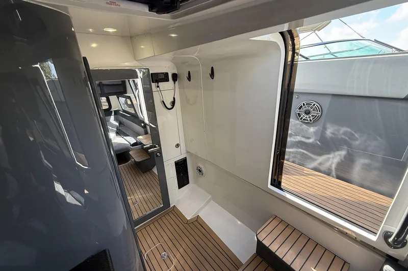Slide: The Image of Interior view of 2023 Midnight Express 43 Solstice yacht, featuring sleek design and wood flooring. - 44
