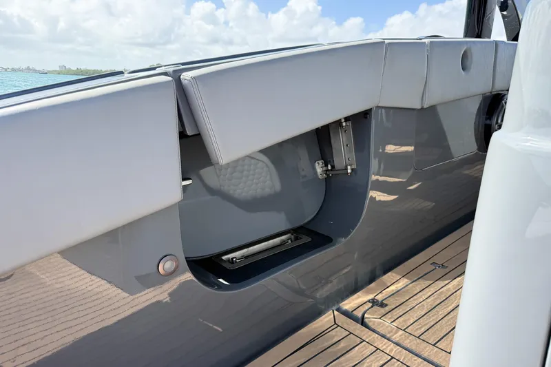 Slide: The Image of 2023 Midnight Express 43 Solstice boat interior with sleek seating and storage compartment. - 46