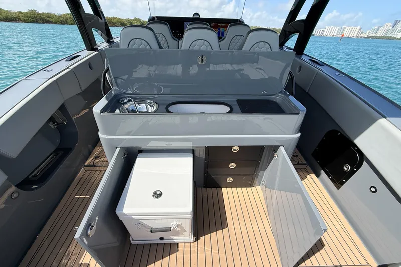 Slide: The Image of 2023 Midnight Express 43 Solstice yacht interior with kitchenette and seating, on a sunny day. - 47