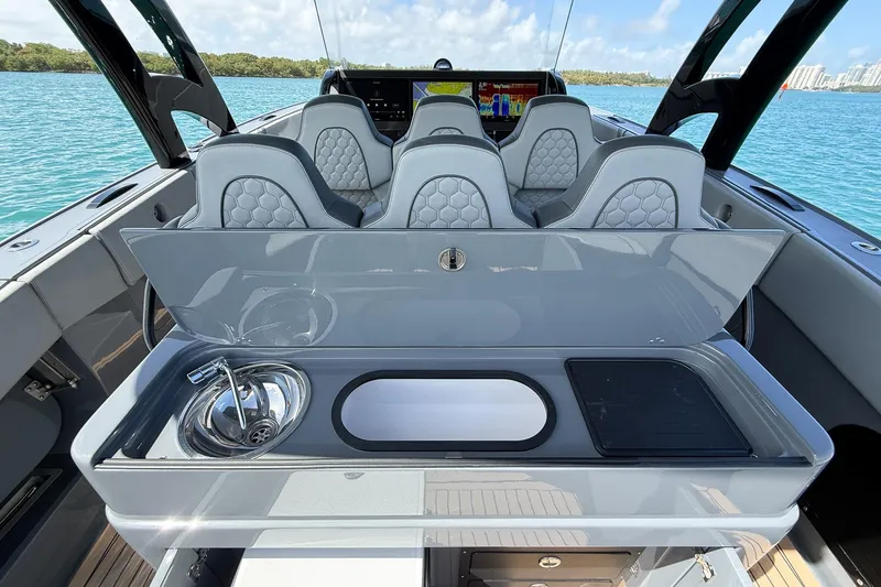 Slide: The Image of 2023 Midnight Express 43 Solstice boat interior with luxury seating and sleek kitchenette. - 48