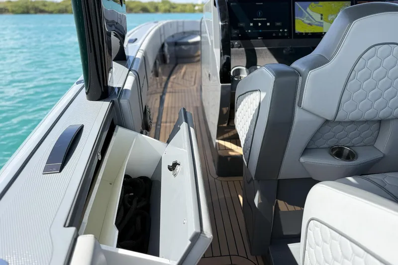 Slide: The Image of 2023 Midnight Express 43 Solstice boat interior with luxury seating and storage compartment. - 50