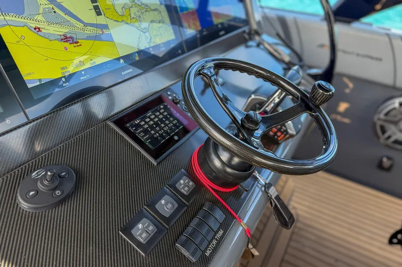 Slide: The Image of Steering console of 2023 Midnight Express 43 Solstice boat with navigation display. - 51