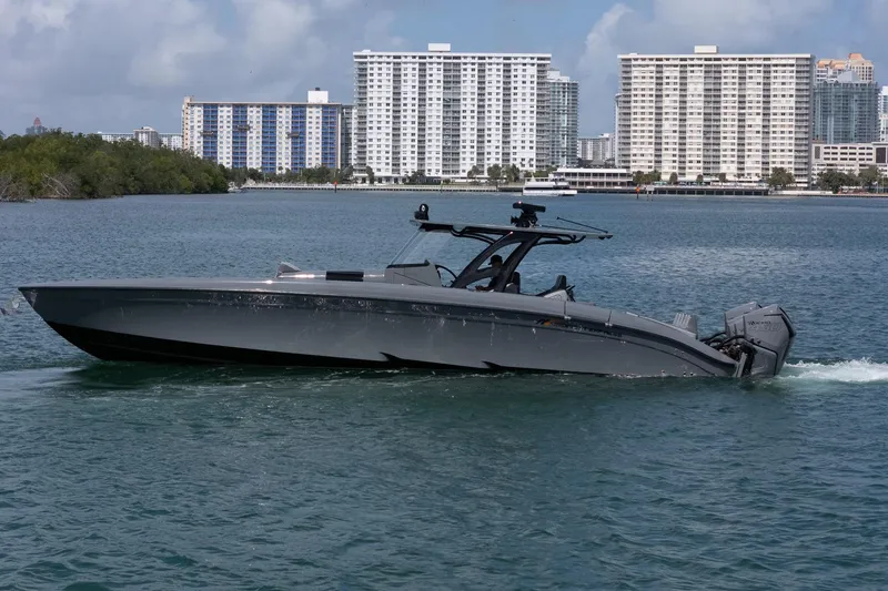 Slide: The Image of 2023 Midnight Express 43 Solstice boat cruising near urban waterfront. - 8