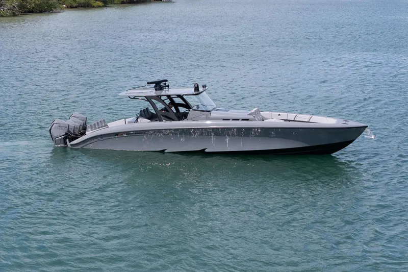 Slide: The Image of 2023 Midnight Express 43 Solstice boat on calm water, showcasing sleek design and powerful engines. - 9