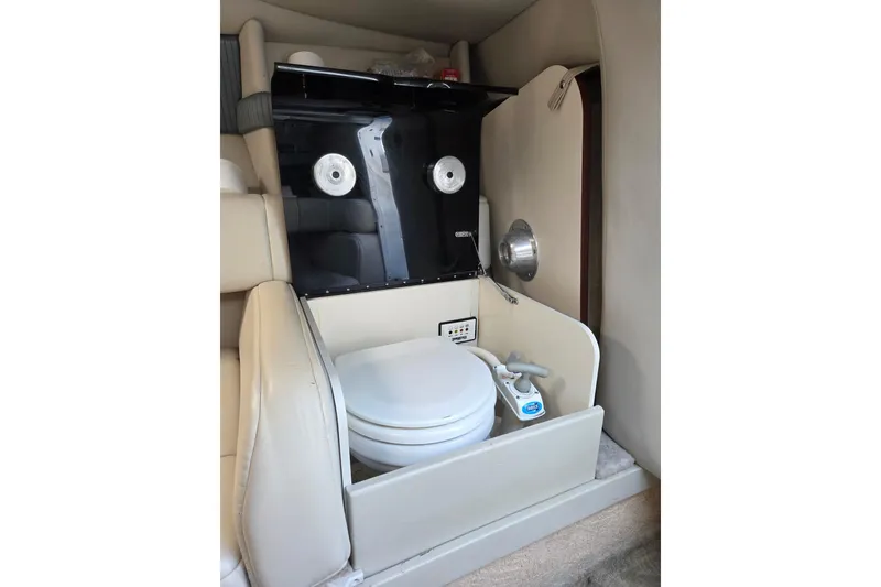 Slide: The Image of 2005 Formula 260 Sun Sport boat interior with compact marine toilet setup. - 10