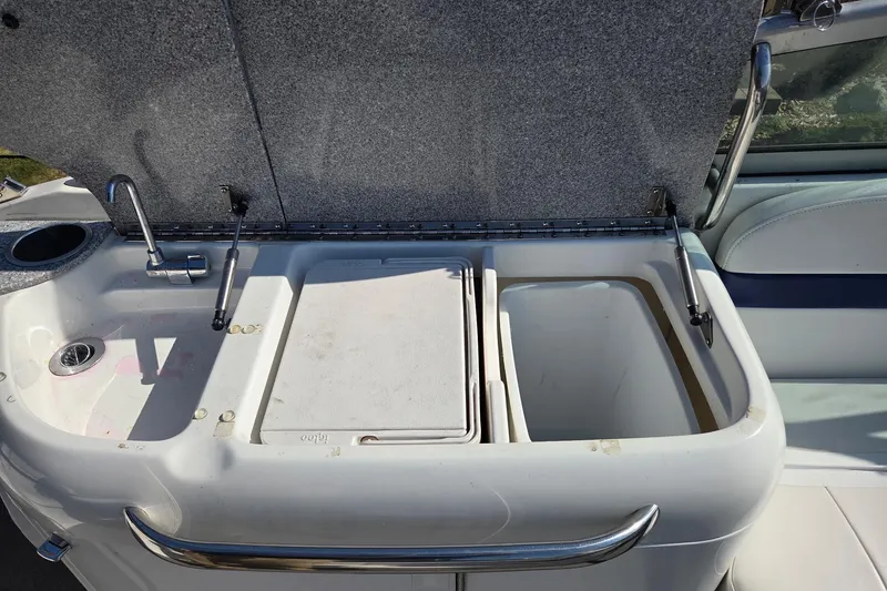 Slide: The Image of 2005 Formula 260 Sun Sport boat sink and storage area with open compartments. - 11
