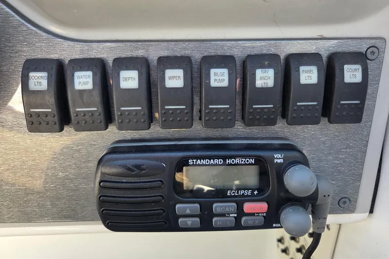 Slide: The Image of Control panel of a 2005 Formula 260 Sun Sport boat with switches and radio. - 14