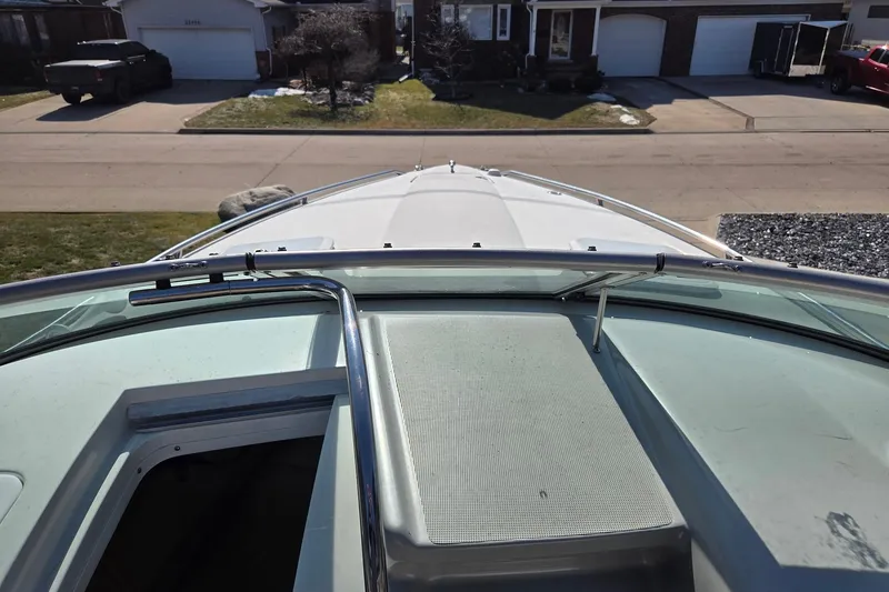 Slide: The Image of 2005 Formula 260 Sun Sport boat parked in a residential driveway. - 17