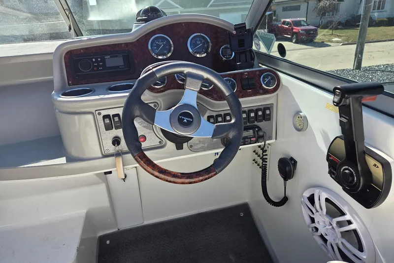 Slide: The Image of 2005 Formula 260 Sun Sport boat dashboard with steering wheel and control panel. - 18
