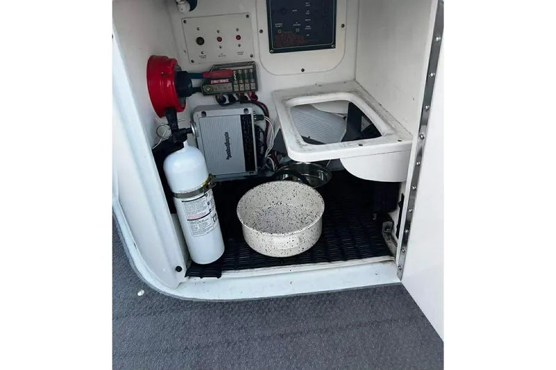 Slide: The Image of 2005 Formula 260 Sun Sport boat interior with fire extinguisher and equipment. - 19