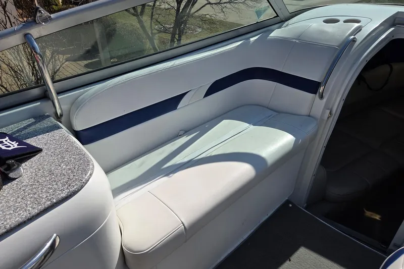 Slide: The Image of 2005 Formula 260 Sun Sport boat interior with white seating and blue accents. - 22