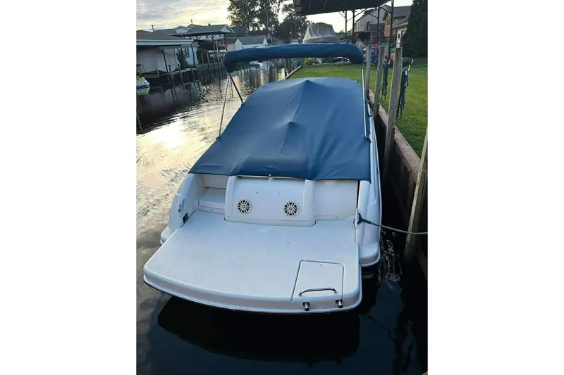 Slide: The Image of 2005 Formula 260 Sun Sport boat docked with blue cover and canopy. - 3
