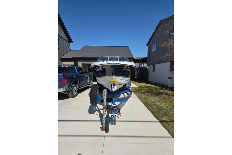 Slide: The Image of 2005 Formula 260 Sun Sport boat on trailer in residential driveway. - 4