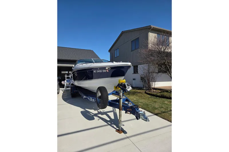 Slide: The Image of 2005 Formula 260 Sun Sport boat on trailer in driveway, near house. - 5