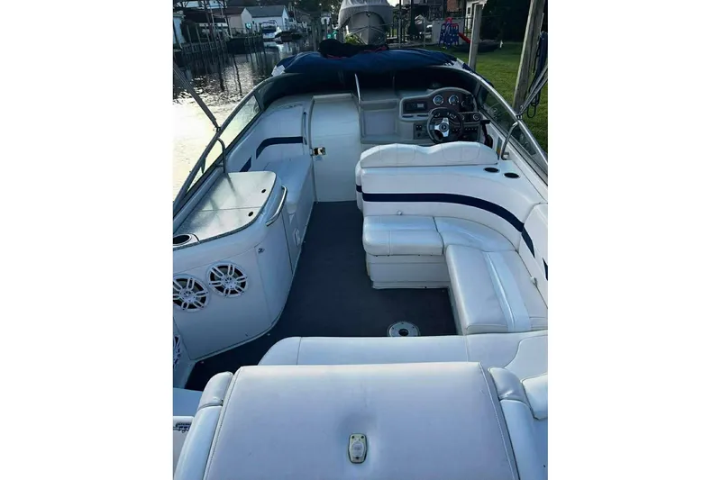 Slide: The Image of 2005 Formula 260 Sun Sport boat interior with white seating and dashboard view. - 7